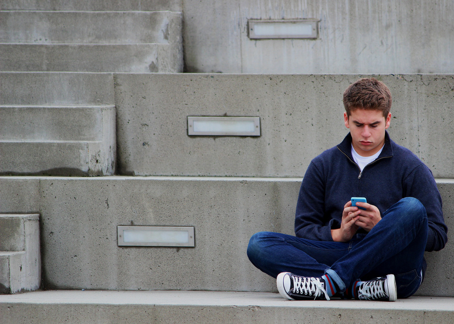 Teenager Using Smartphone Outdoors
